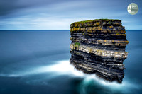 Dun Briste Sea Stack at Downpatrick Head in County Mayo Ireland with Long Exposure Smooth Water and Clouds