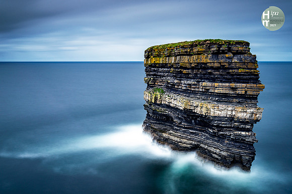 Dun Briste Sea Stack at Downpatrick Head in County Mayo Ireland with Long Exposure Smooth Water and Clouds