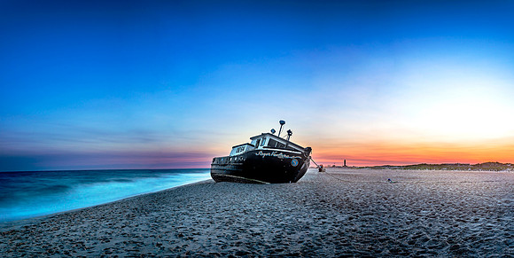 Panoramic of Shipwrecked Boat F.V. Roger Ventures on Jones Beach State Park Long Island in New York at Sunset with Long Exposure of Atlantic Ocean